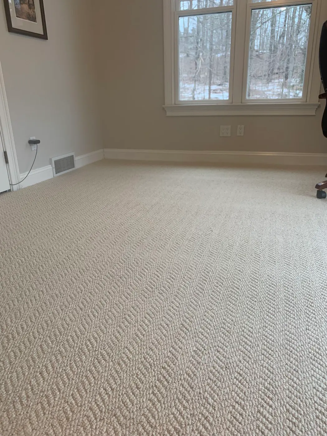 Empty bedroom with neutral painted walls and a double window